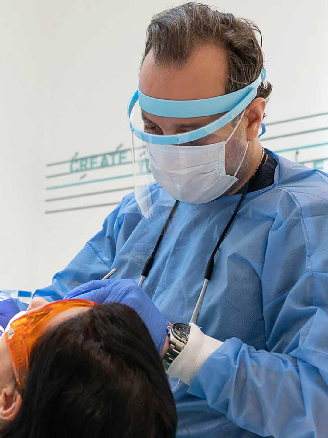 One of Harmony Medical Center’s dentists performing a dental checkup during a patient’s first visit.