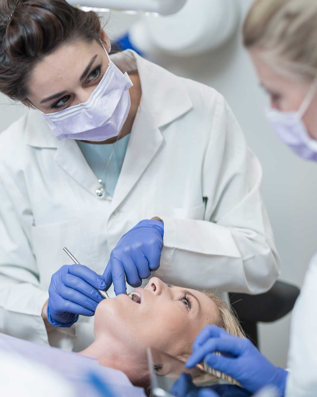 Periodontal team at Harmony Medical Center discussing gum disease treatment with a patient.