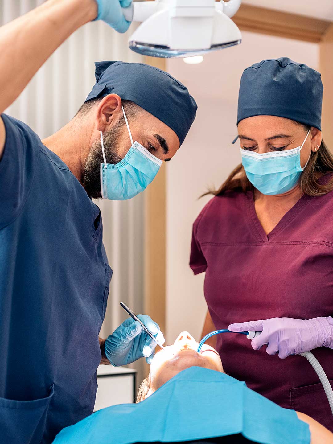 Specialist periodontist and nurse at Harmony Medical Center performing gum graft surgery.
