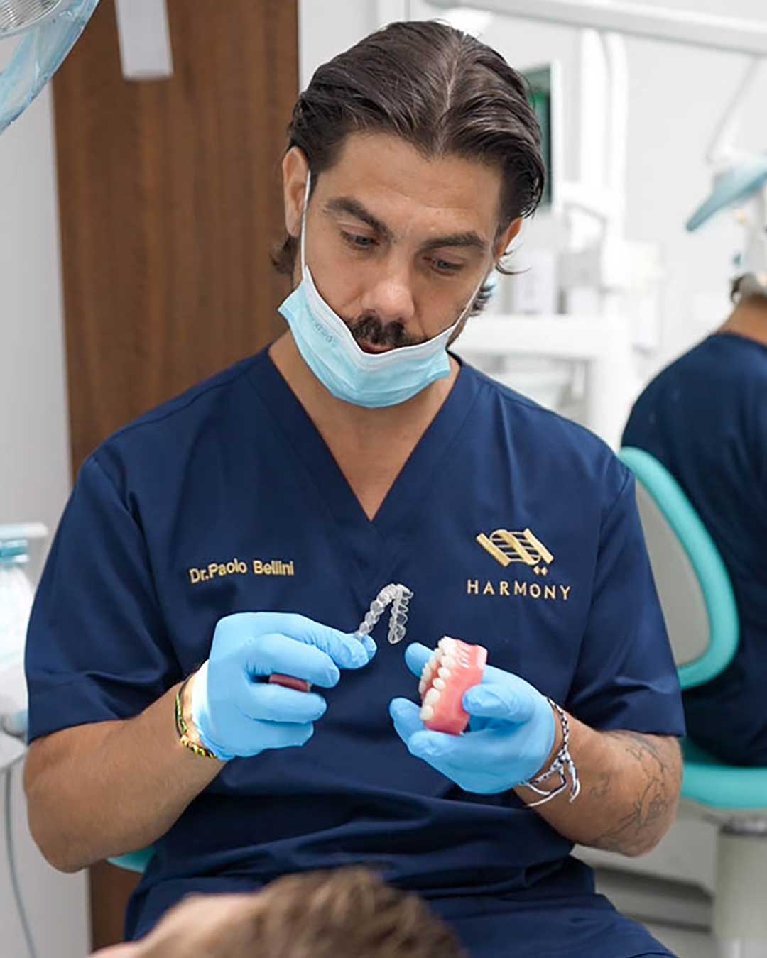 A photo of Italian Orthodontist, Dr. Paolo Bellini, with a patient at Harmony Medical Center in Dubai
