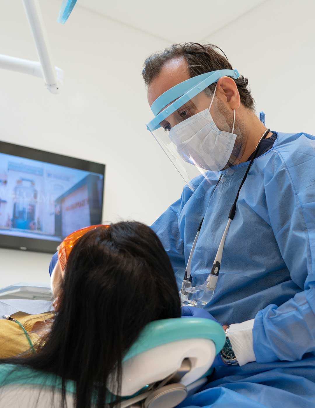 Photo of Dr. Iyad Al Samman, Head of Orthodontics at Harmony Medical Center, with a smiling patient after treatment.