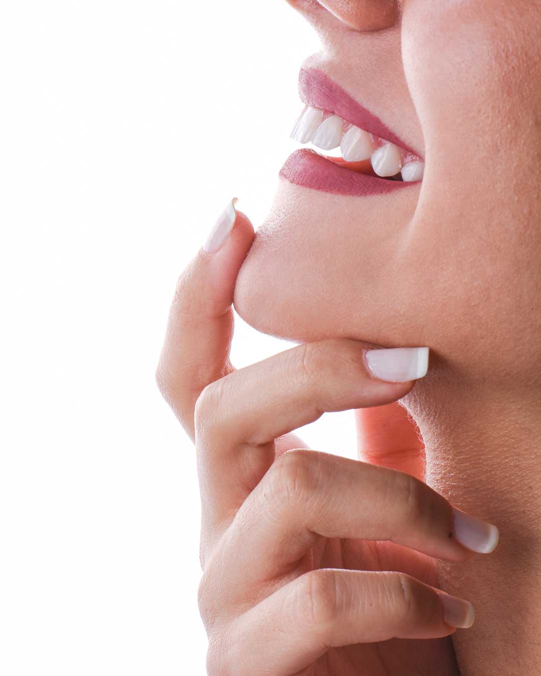 Image of a lady smiling with beautiful, natural-looking veneered teeth.