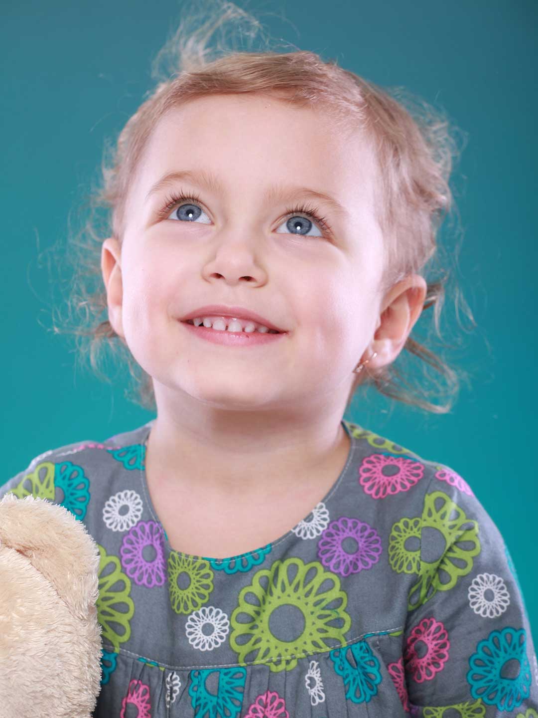 A photo of a little blond girl smiling