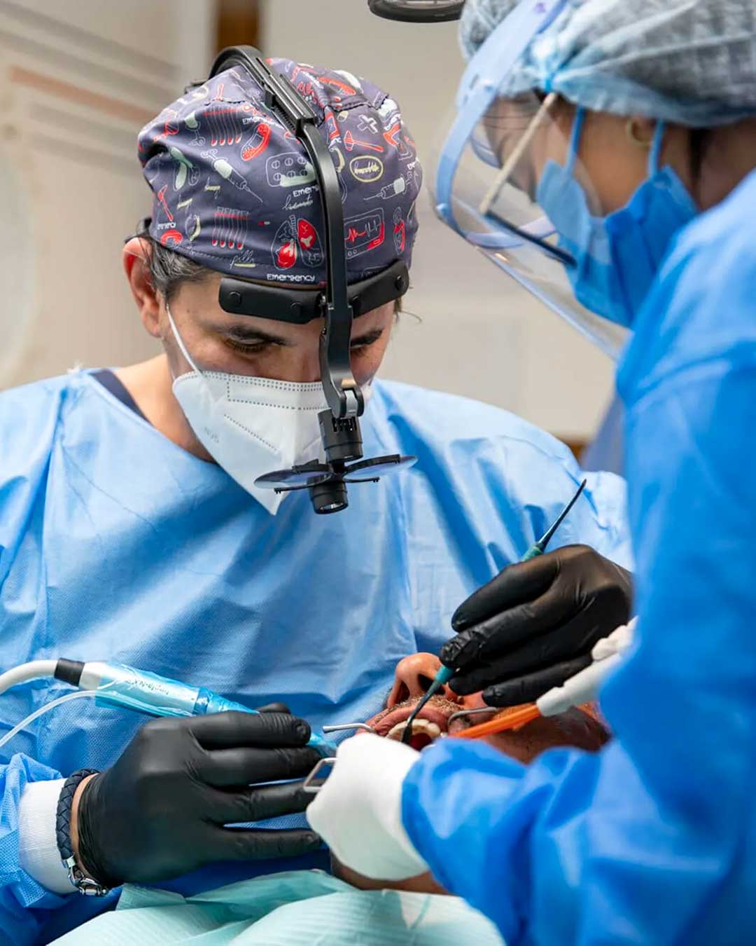 A photo of Dr. Ahmad Al Jazairi, Harmony Medical Center's Head Oral & Maxillofacial Surgeon with a male patient.