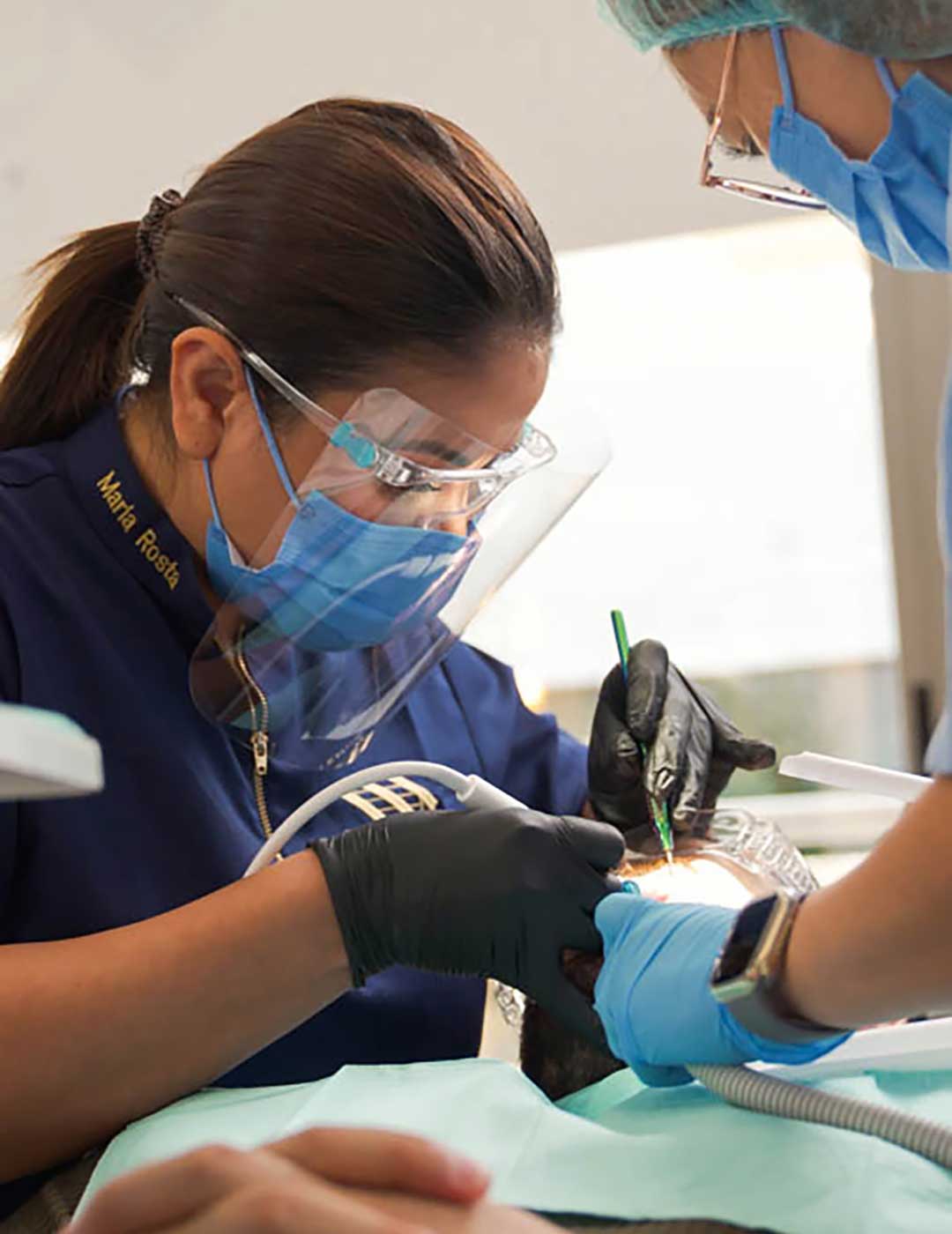 Dental Hygienist Maria Rosta with a patient at Harmony Medical Center Dubai during a teeth cleaning (GBT) session.
